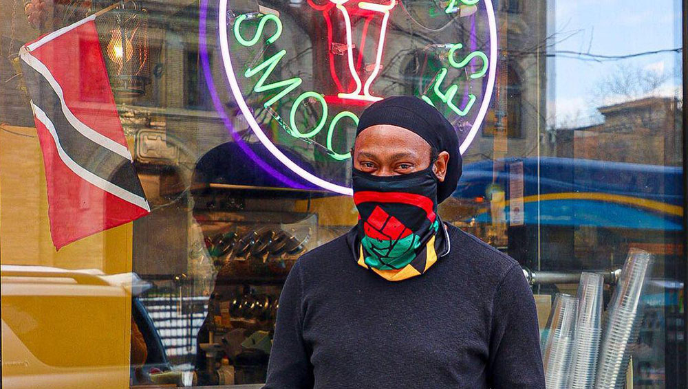 Man with facemask standing in front of his business for Popular Business Directory influencer campaign